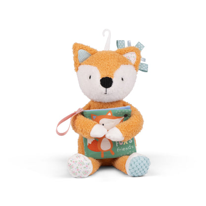 Plush fox toy holding a book
