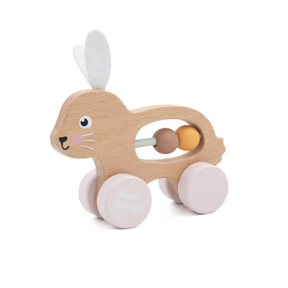 Wooden toy bunny with wheels and beads on a white background