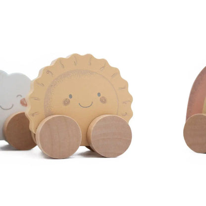 Wooden toy sun on wheels with a smiling face on a white background