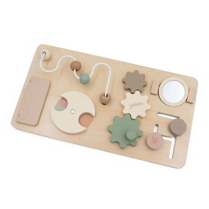 Wooden busy board toy with various shapes and textures on a white background