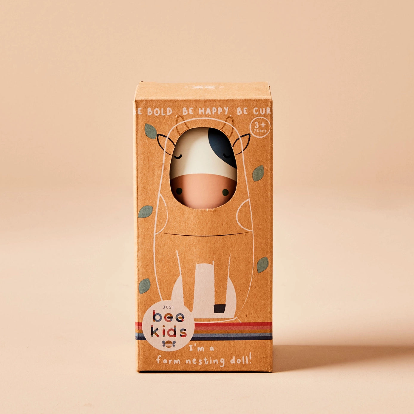 Boxed stacking toy with a farm animal design on a beige background