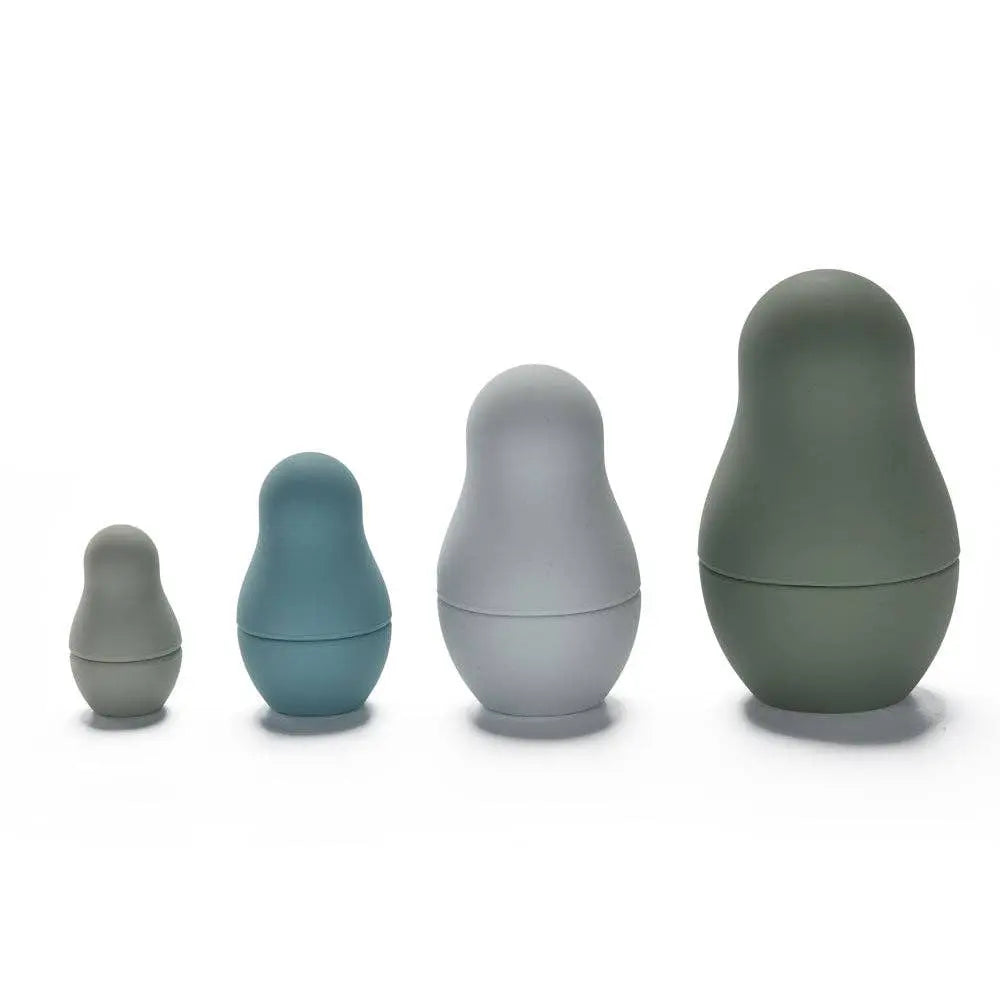 Set of four pastel coloured nesting dolls on a white background