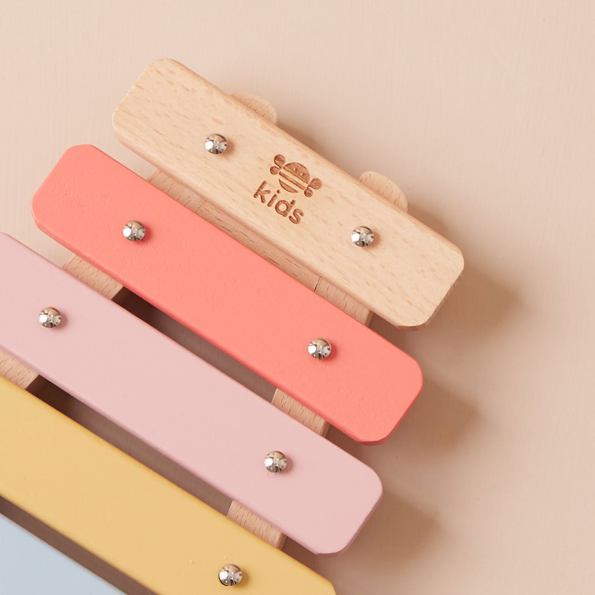 Colourful wooden xylophone toy on a beige background