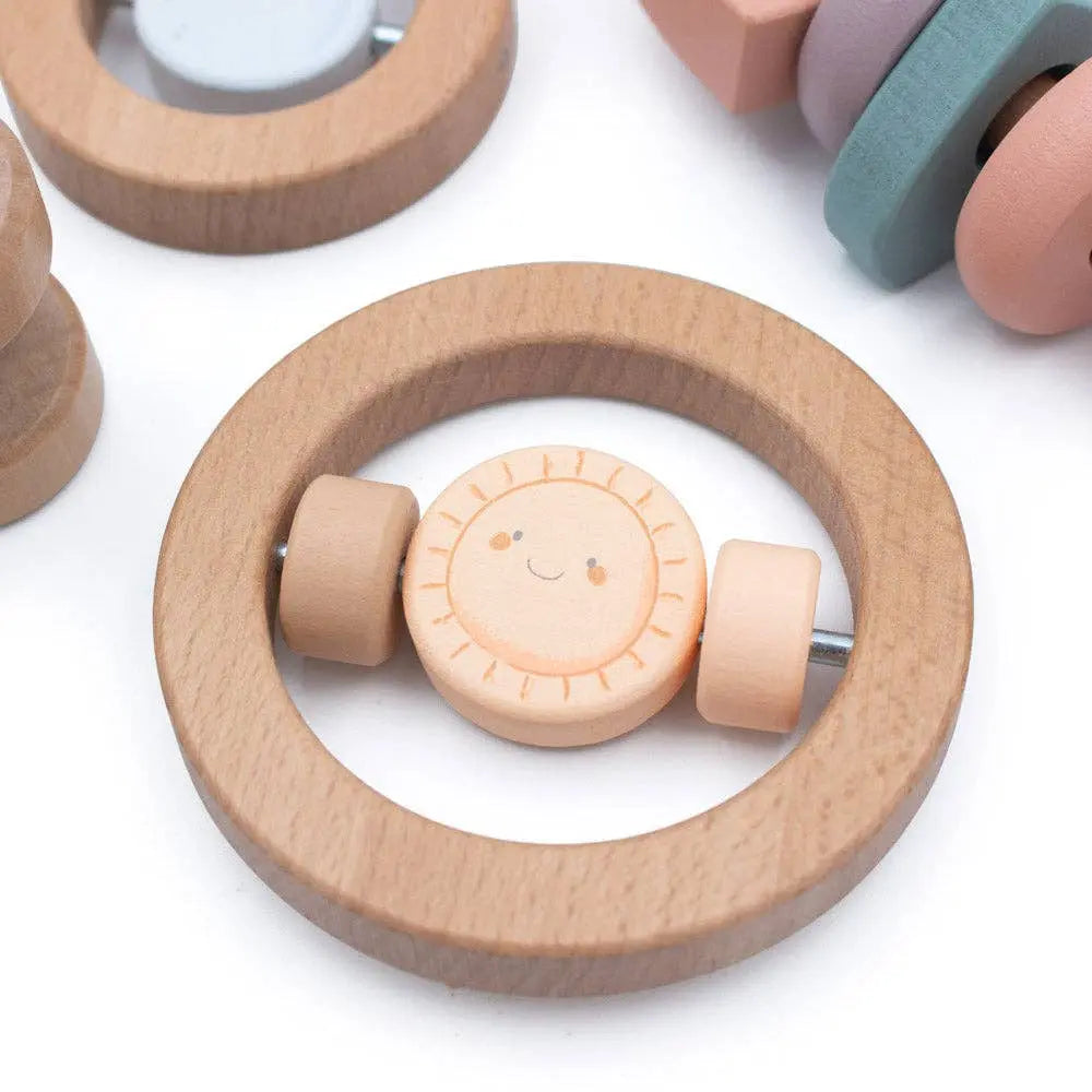 Wooden teething ring with a smiley face design on a white background