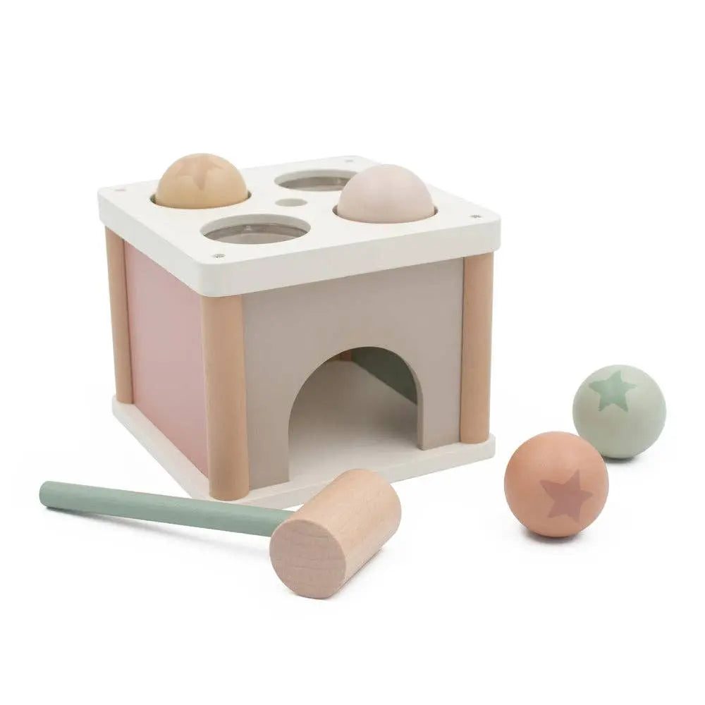 Wooden toy with compartments and a hammer on a white background