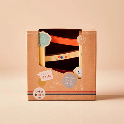 Box packaging for a children's roller toy with 'just bee kids' branding on a beige background