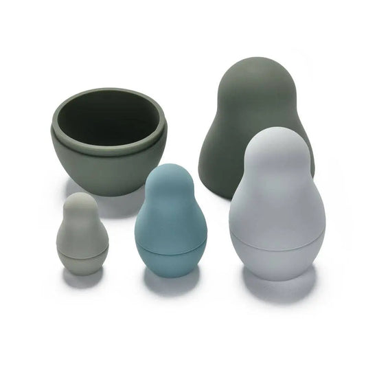 Set of five nested silicone dolls in various shades of green/blue/grey on a white background