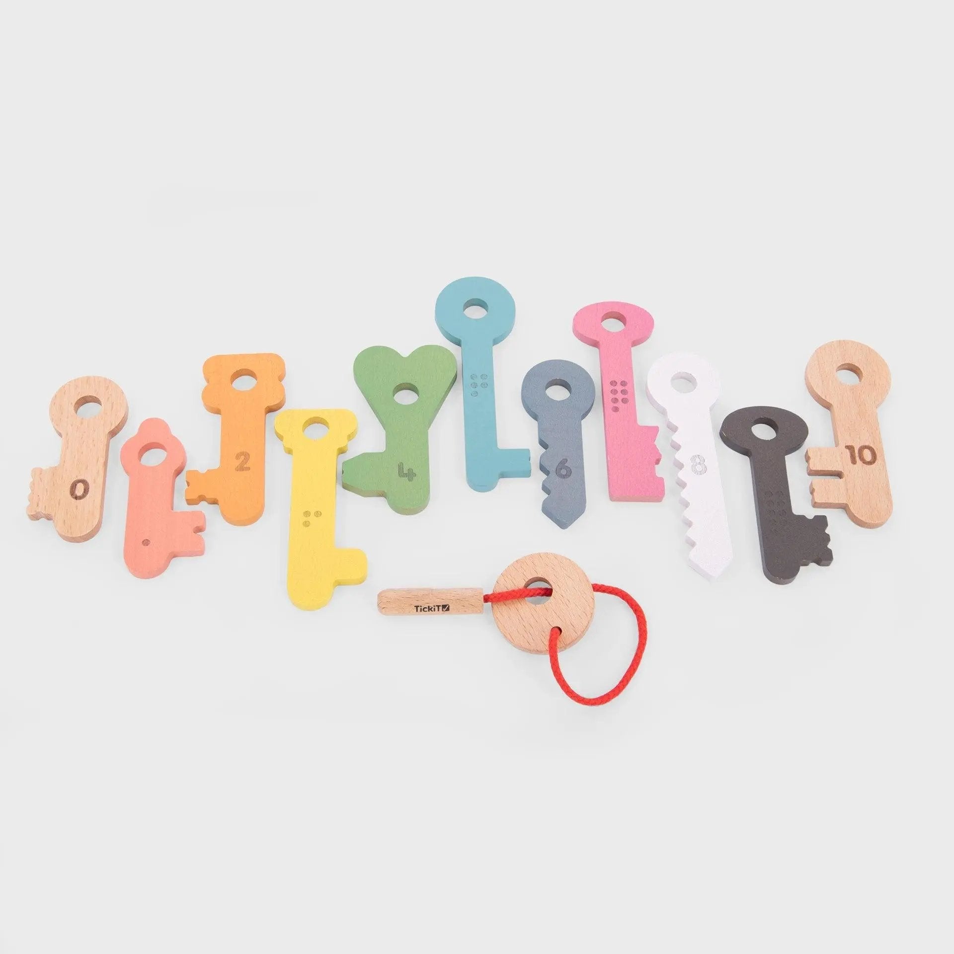 Colourful key-shaped toys on a light grey background