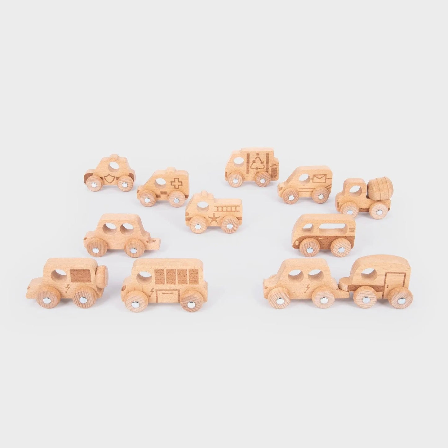 Set of small wooden toy cars on a light grey background