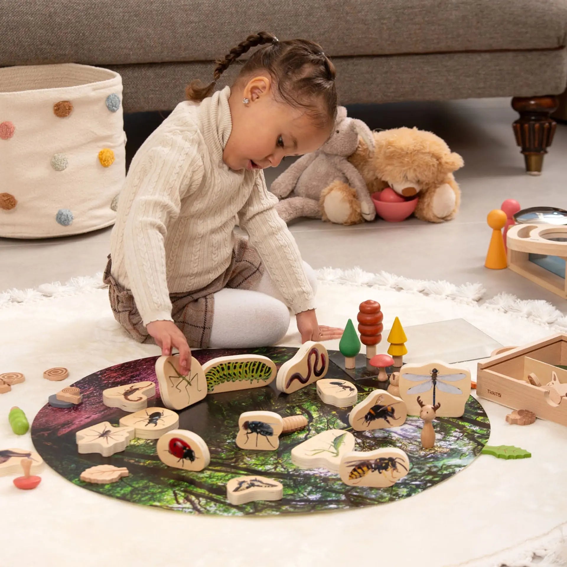 Child playing with wooden toys on a rug