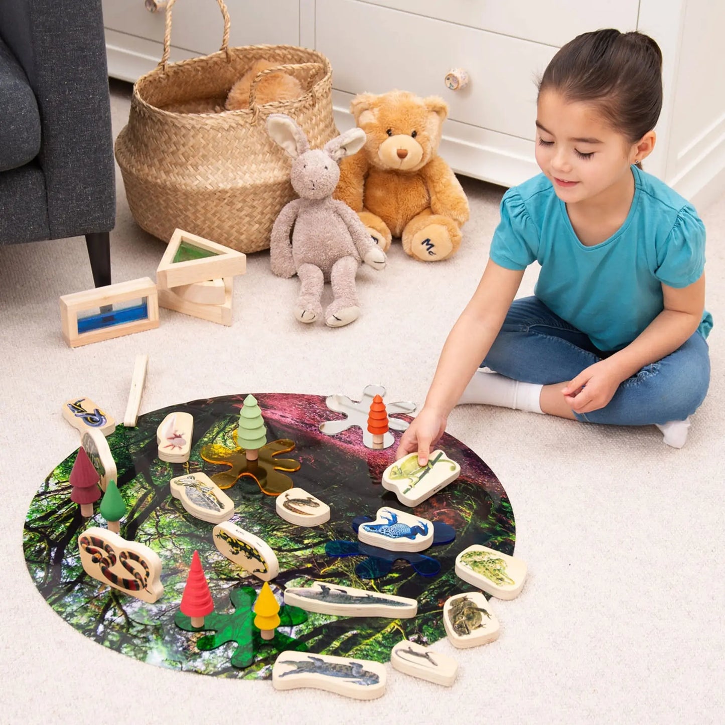 Child playing with a nature-themed educational toy on the floor.