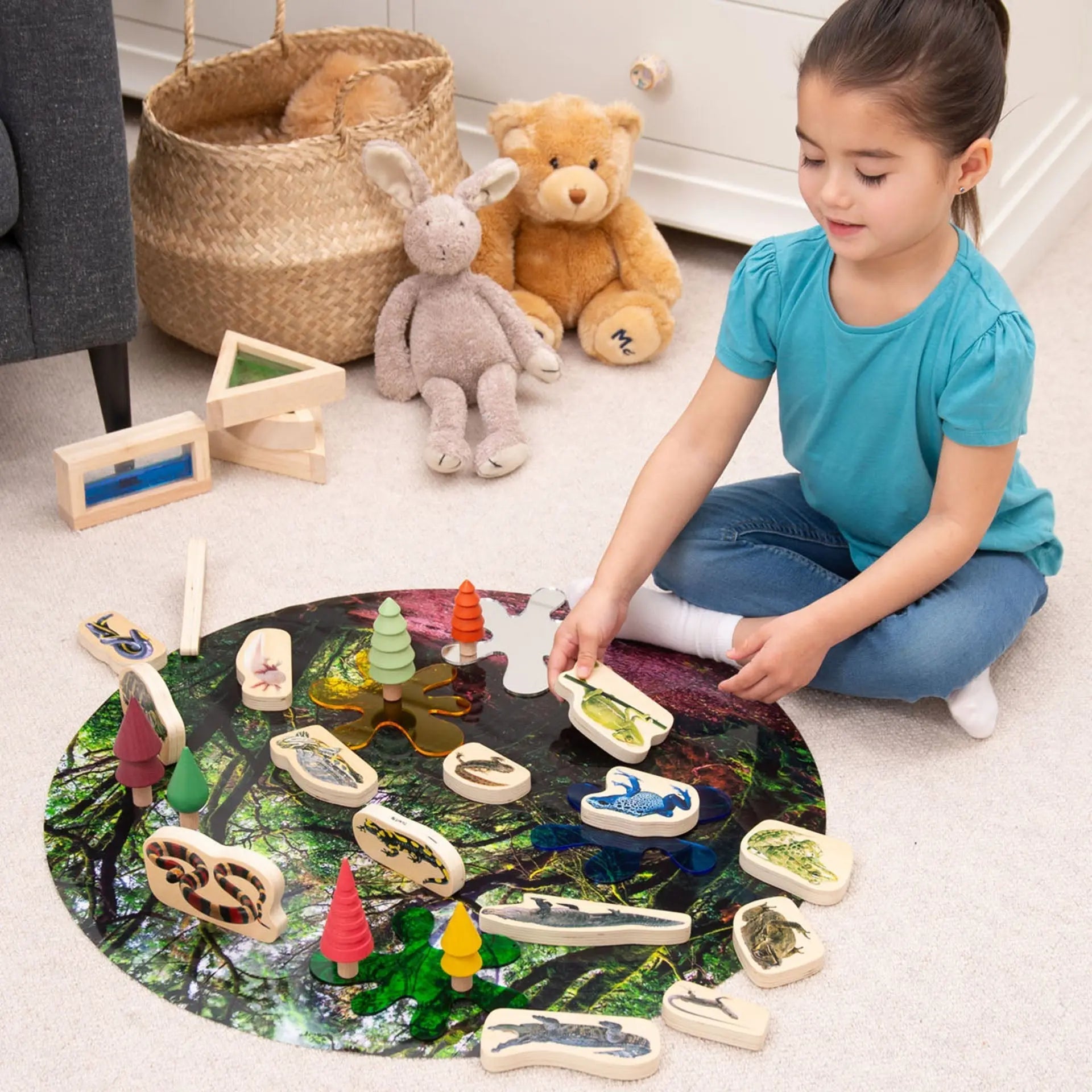 Child playing with wooden animals on a colourful mat in a room with toys.