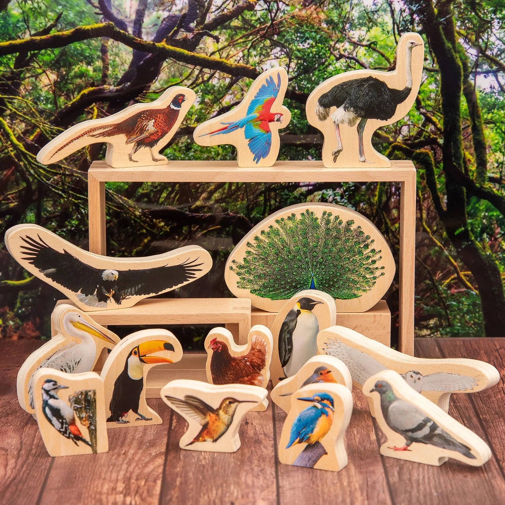 Set of wooden bird figurines on a wooden surface with a natural background