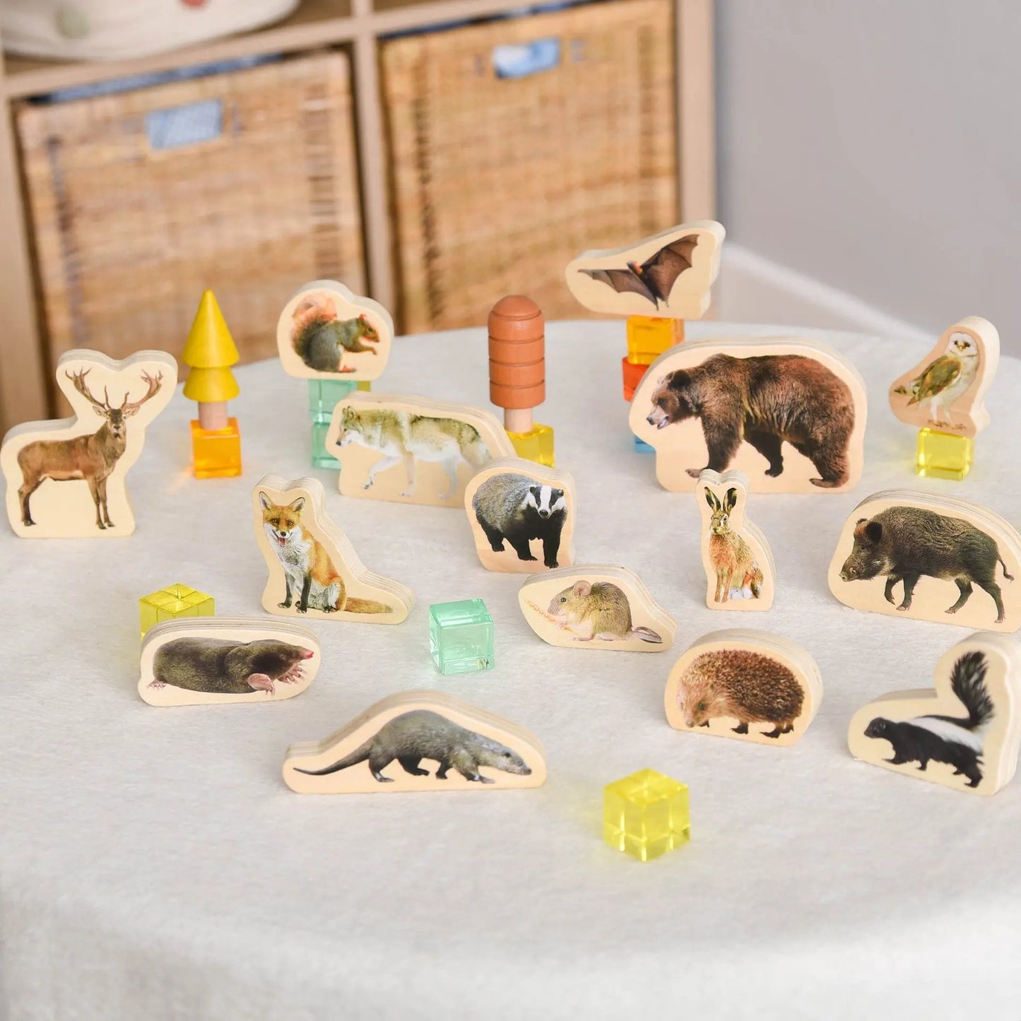 Set of wooden animal figurines on a light surface with a blurred background