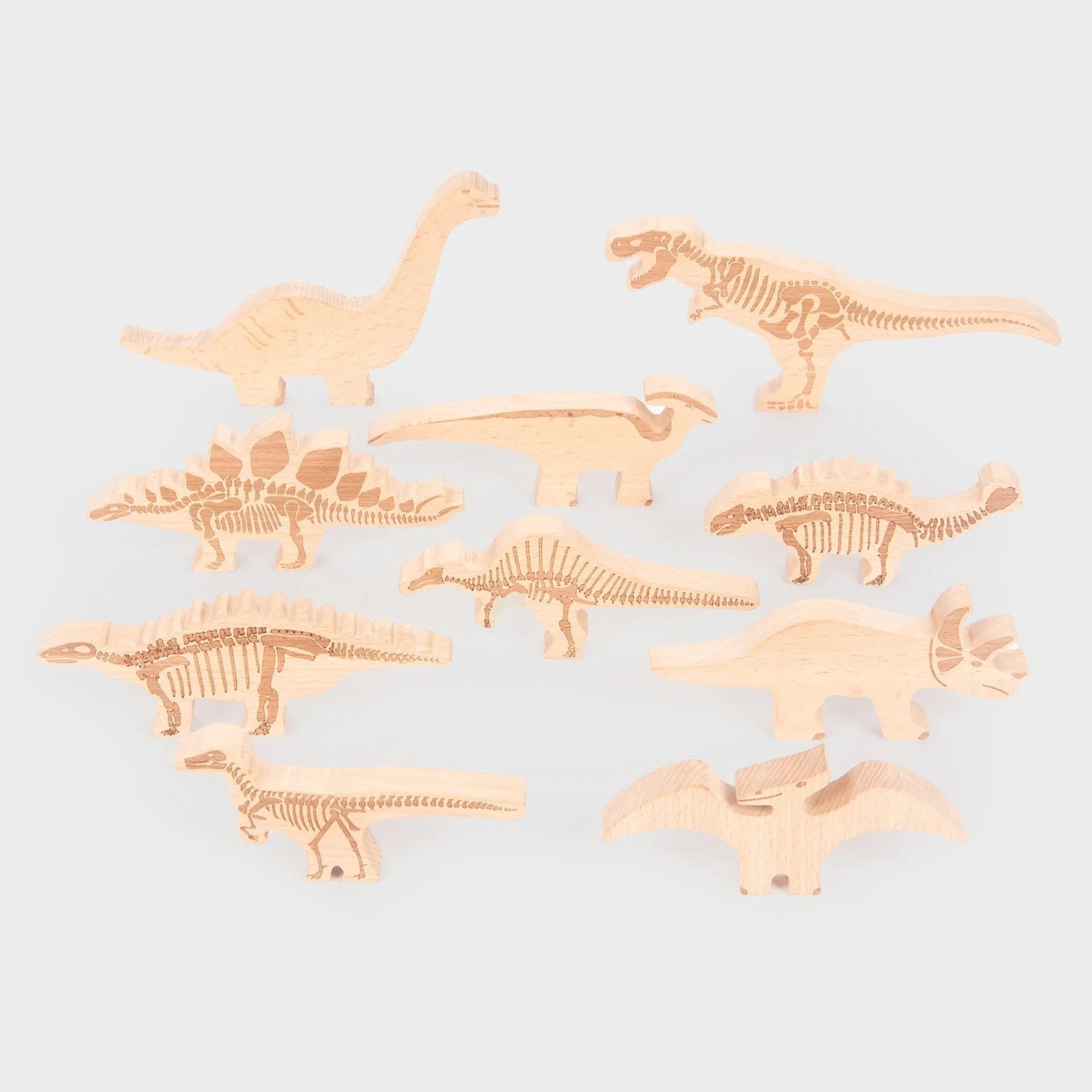 Set of dinosaur toys on a light grey background