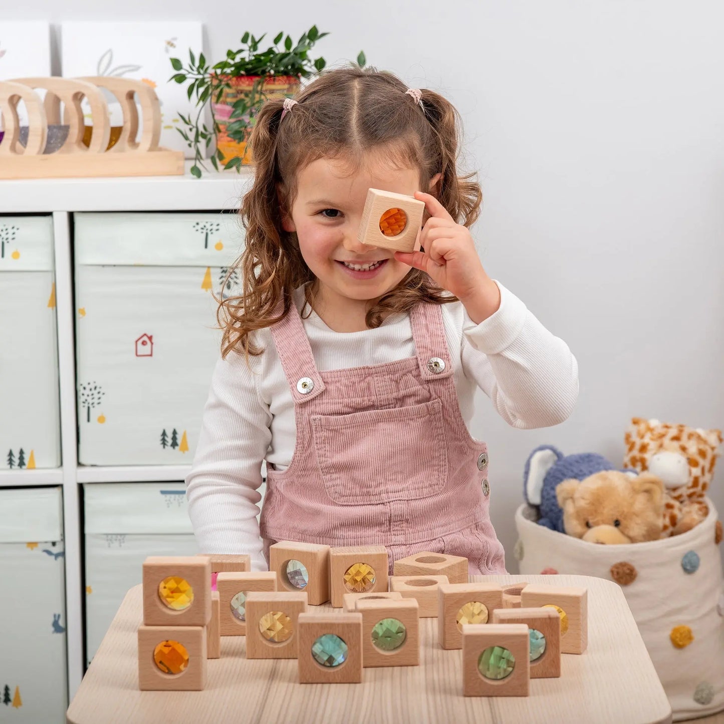 Child playing with wooden blocks in a playroom setting