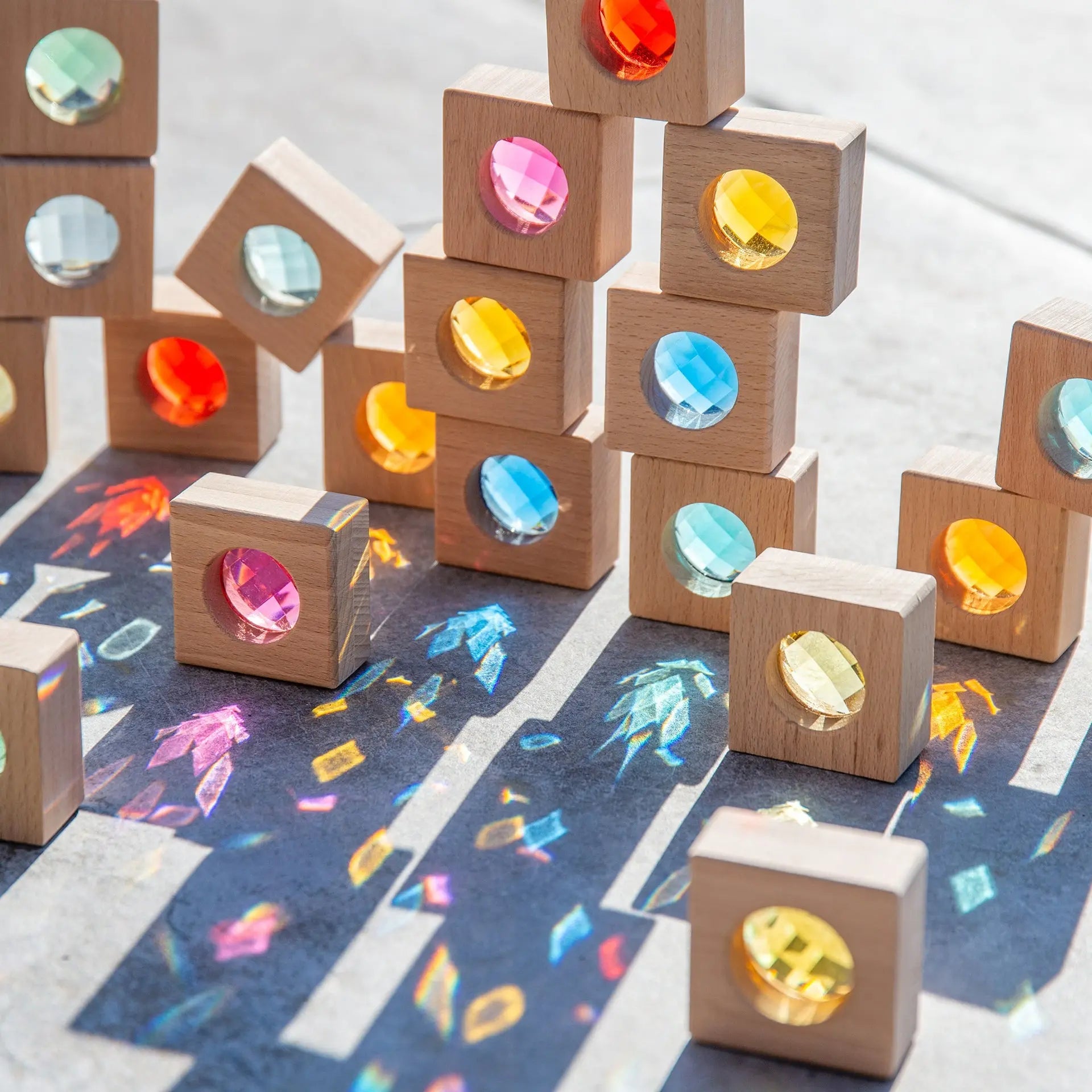 Wooden blocks with colourful gemstones on a patterned surface