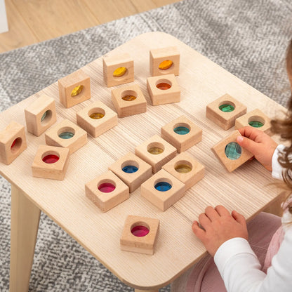 Child playing with a wooden educational toy on a table