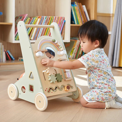 Child playing with a wooden activity toy in a room with bookshelves.
