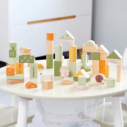 Colourful wooden blocks on a white table with a neutral background