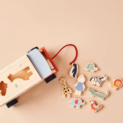 Wooden toy jeep with shape sorter and animal figures on a beige background