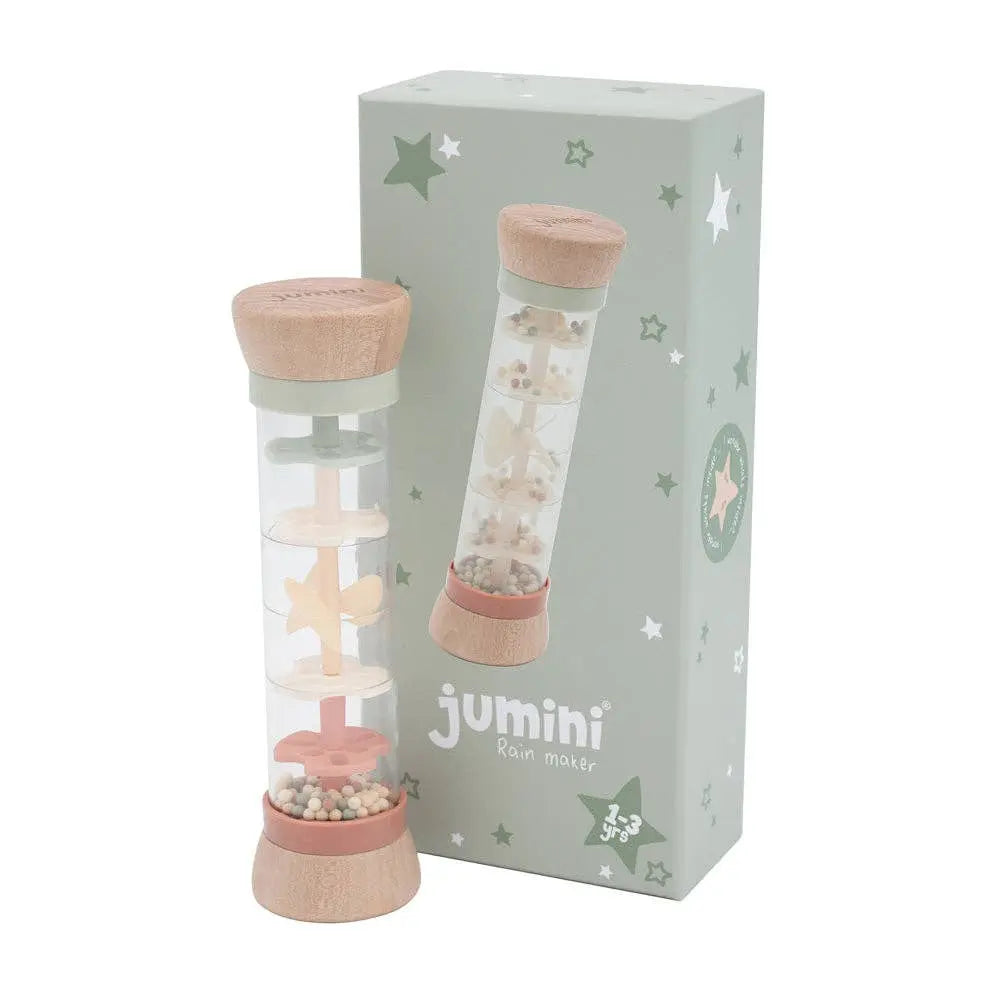 Jumini rain maker with pink lid and base in front of its packaging on a white background