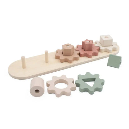 Wooden shape sorting toy with pastel-coloured shapes on a white background