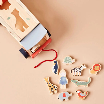 Wooden toy jeep with animal figures on a beige background