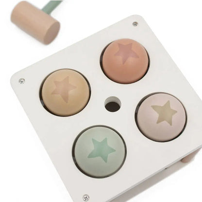 Pounding box with four star-shaped coloured balls on a white background