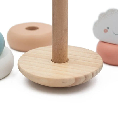 Wooden ring stand with colorful rings on a white background