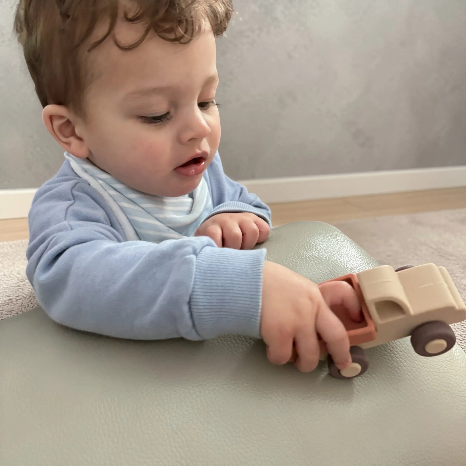 Toddler playing with silicone truck