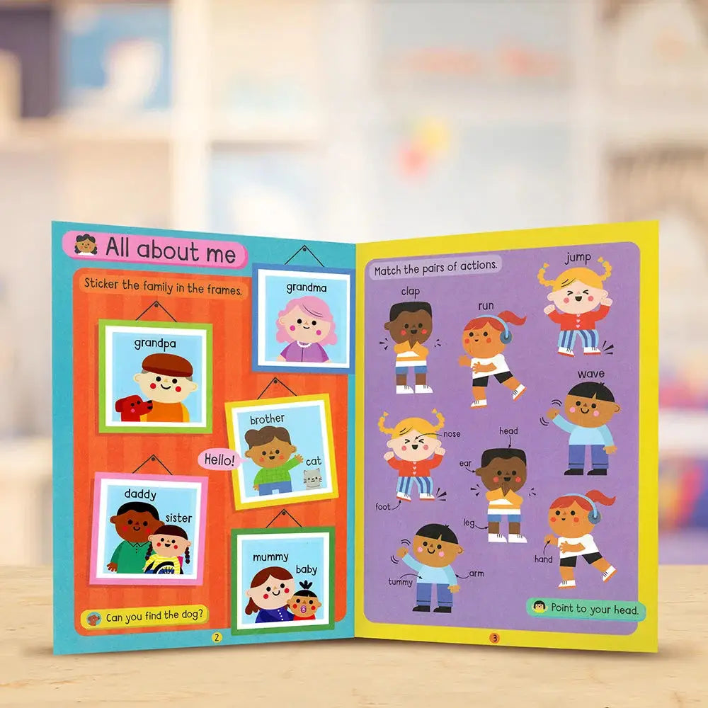 Educational children's book open to pages with illustrations and text on a wooden surface.