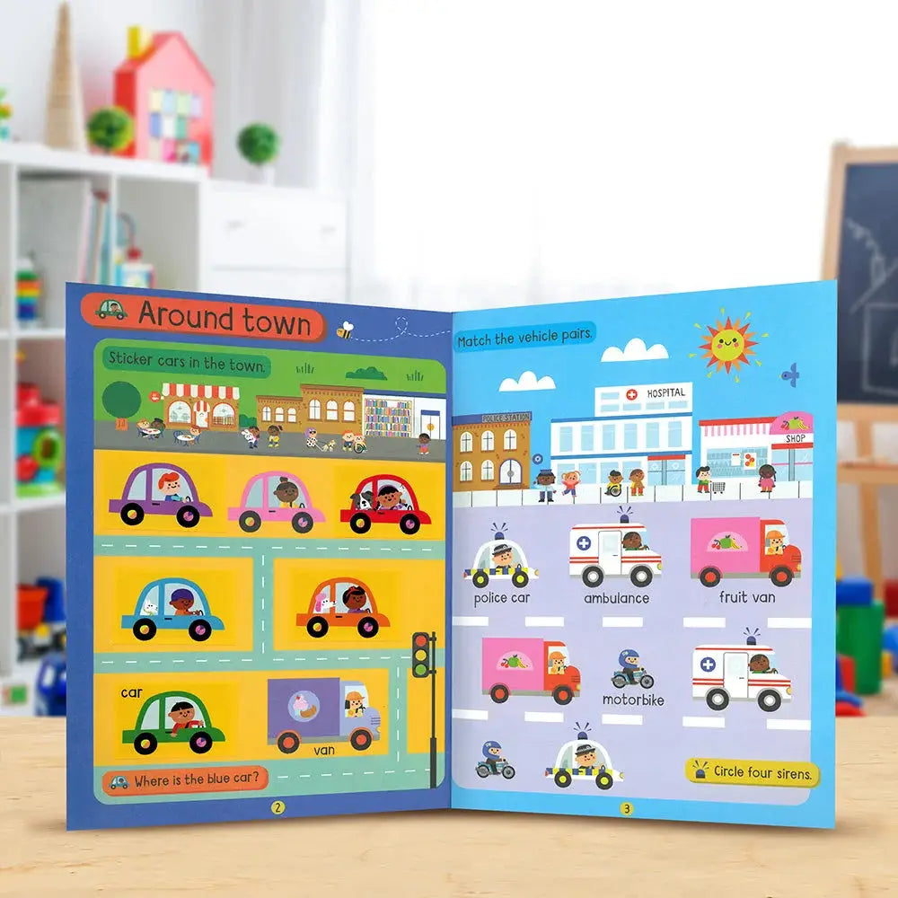 An open children's educational sticker-and-match activity book titled 'Around town' showing colourful cartoon vehicles and road scenes on both pages, photographed on a tabletop with a blurred playroom background.