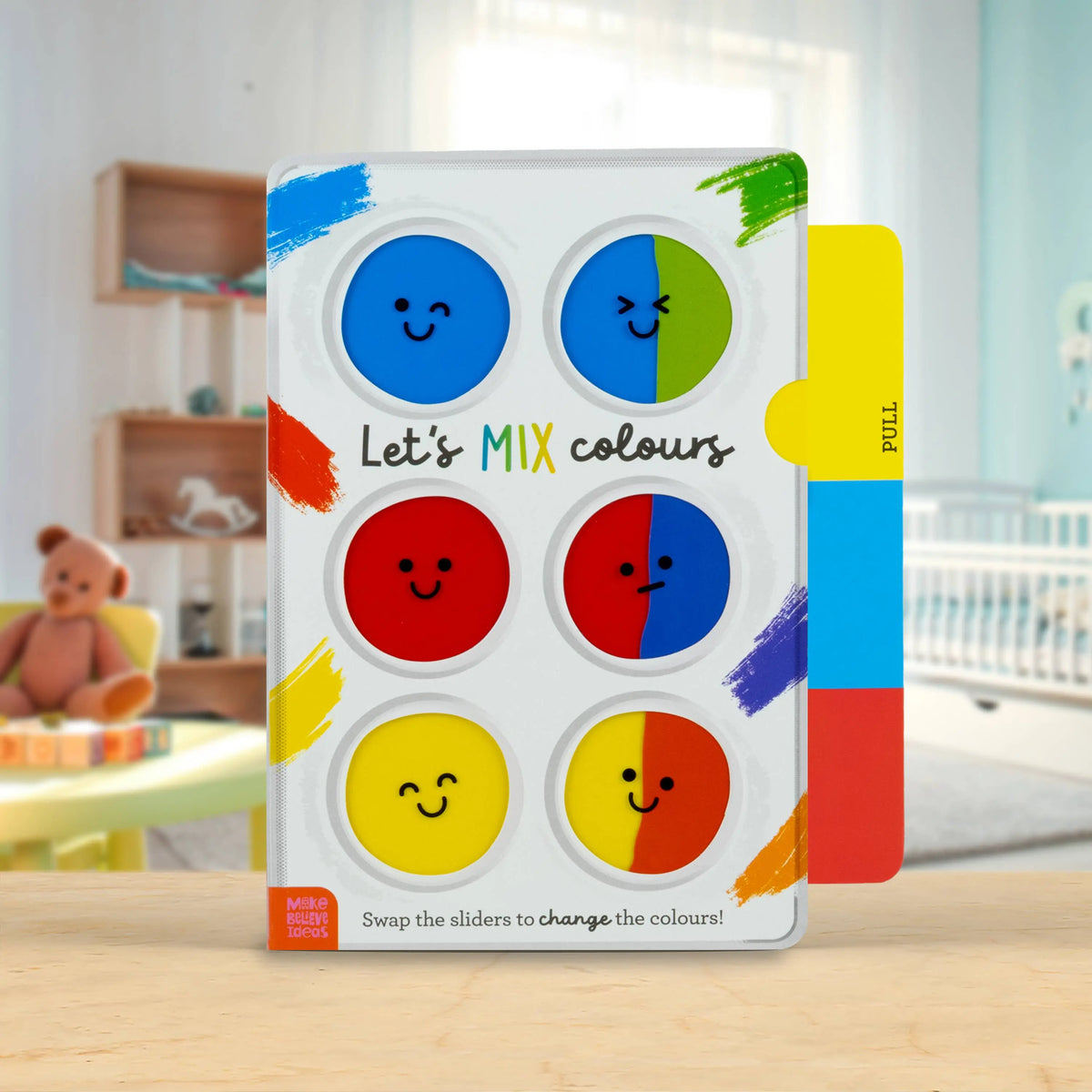 Colour mixing book for children with colourful slides on a wooden surface