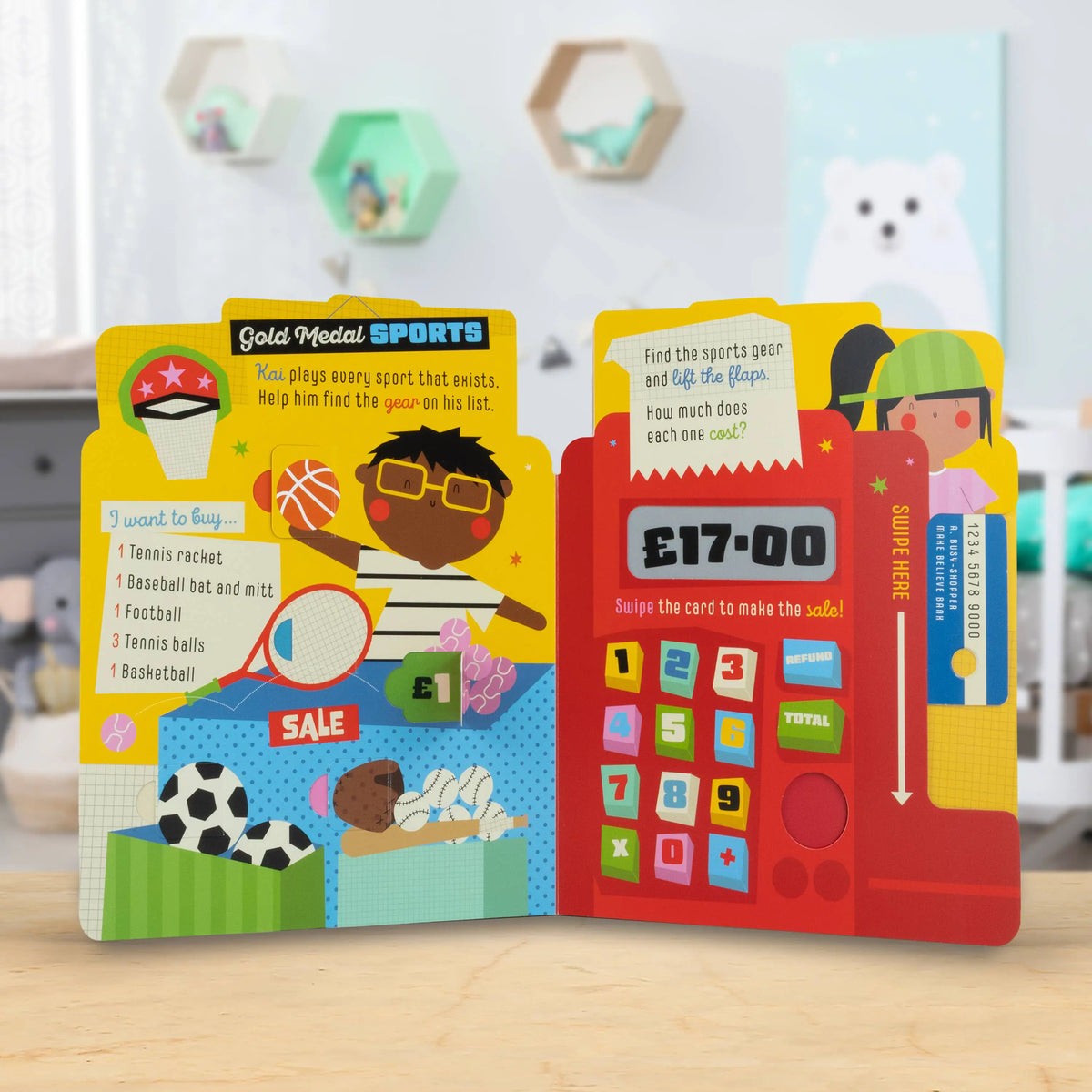 Children's educational book with sports theme and calculator design on a wooden surface.