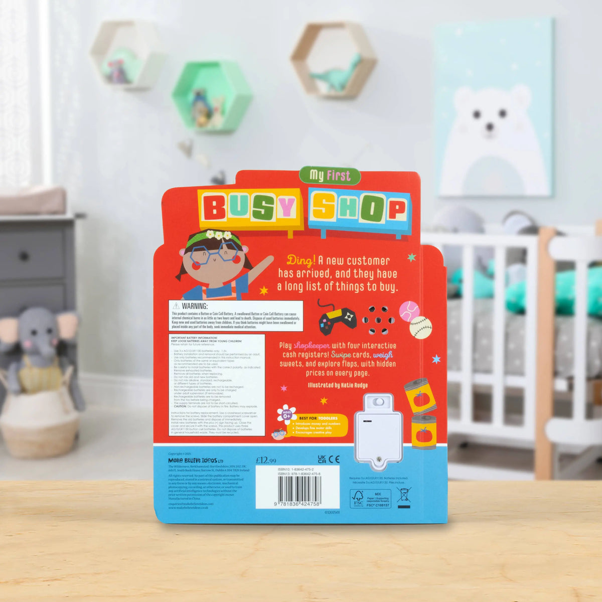Children's toy packaging with 'My First Busy Shop' branding in a nursery setting.