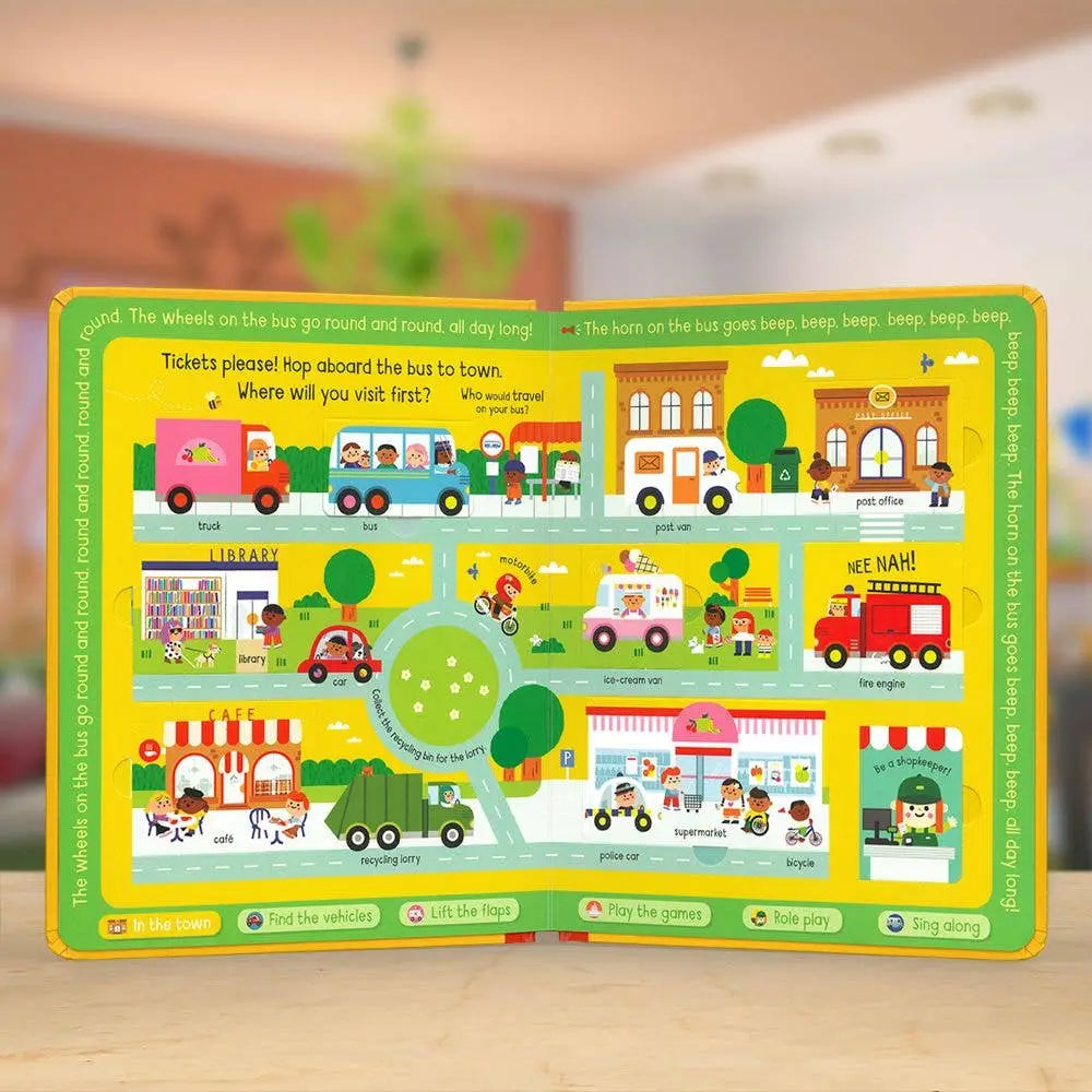 Children's educational board book with colourful illustrations of a bus route and vehicles on a wooden surface.