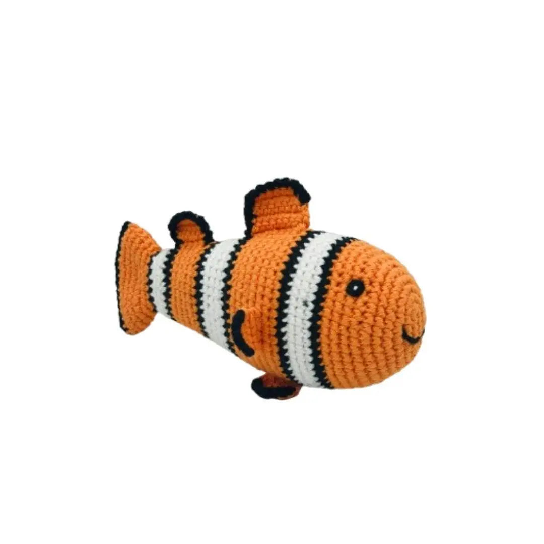 A crocheted clownfish toy with orange, white, and black stripes, featuring a smiling face and small black feet, isolated on a white background.