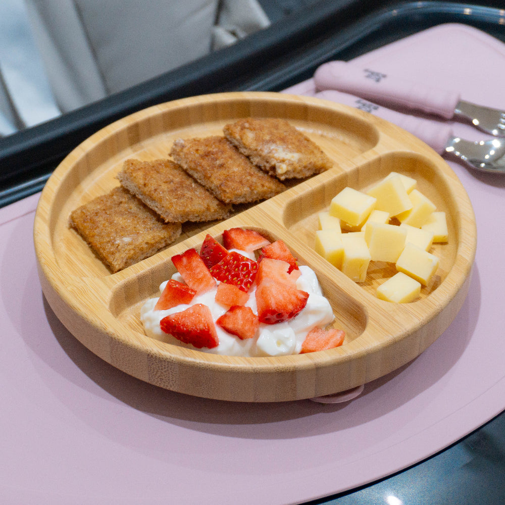 round bamboo plate on high chair with food