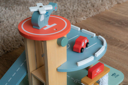 Toy garage with car on a wooden surface