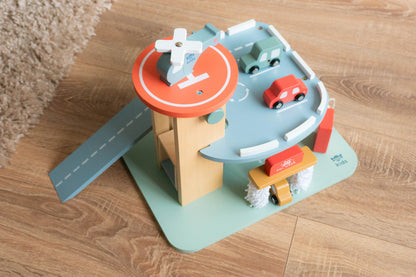 Toy car garage set with cars on a wooden floor