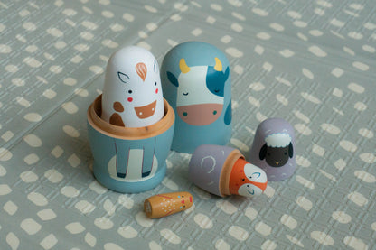 Set of wooden toys shaped like animals on a patterned surface