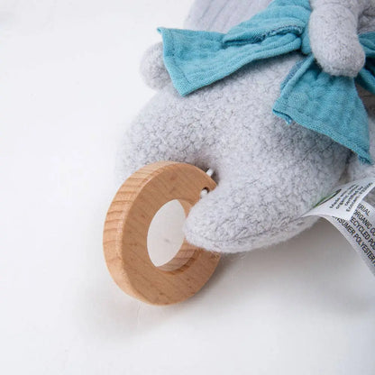 Plush toy with a wooden teether on a white background