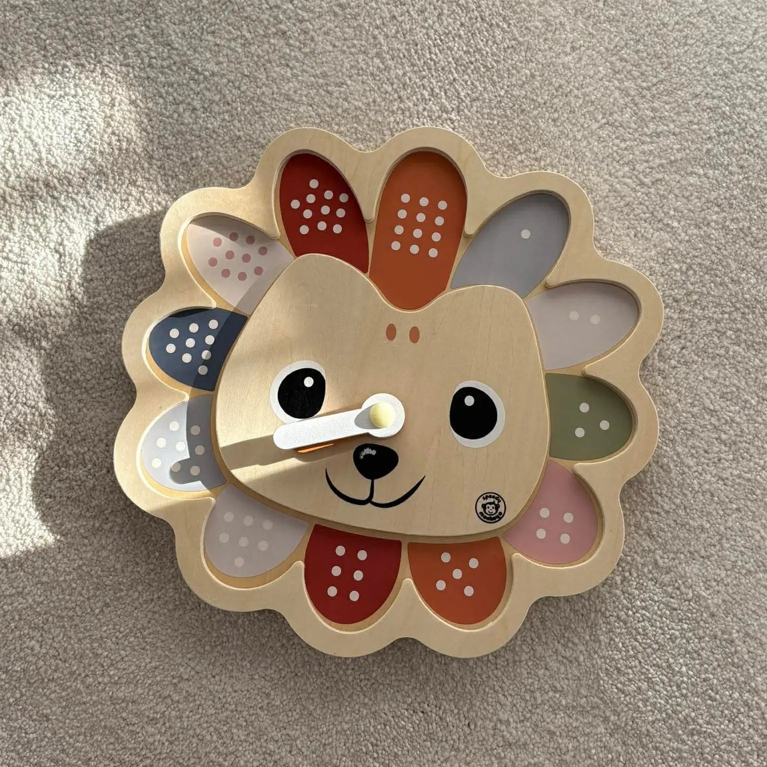 Decorative wall piece with a cartoon hedgehog design on a textured beige background
