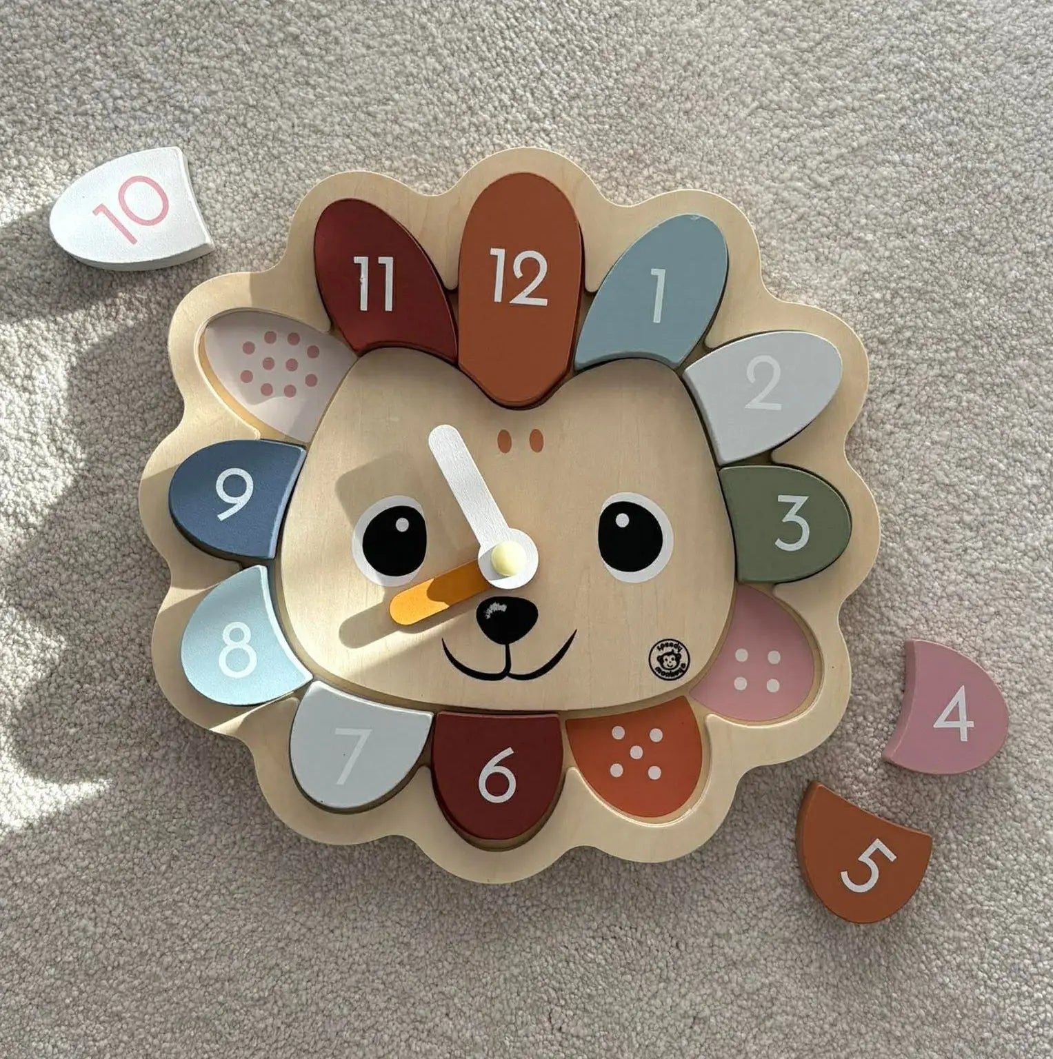 Children's clock with a hedgehog design on a light grey background