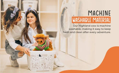 A woman and a young girl kneel in a laundry room next to a washing machine, holding a small plush Highland cow toy inside a white laundry basket. Text on the right reads 'MACHINE WASHABLE MATERIAL' with supporting copy about keeping the toy fresh and clean.