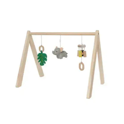 A natural wood baby mobile frame with hanging toys including a green leaf, a grey elephant, and small wooden bells, shown on a plain white background.