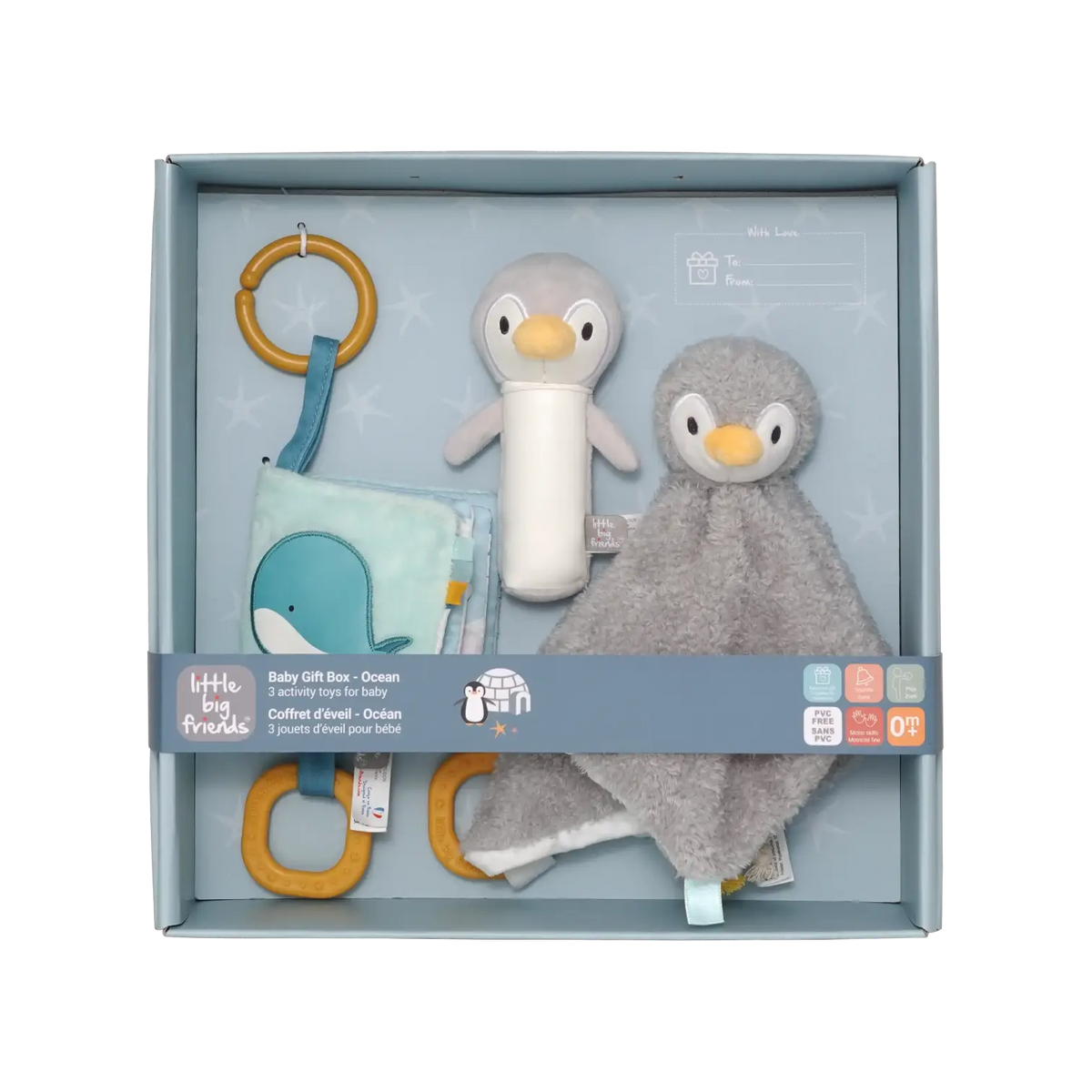 A baby gift set by Little Big Friends inside a light blue box, featuring a plush penguin toy, a grey penguin comforter, a blue whale fabric toy, and wooden ring toys.
