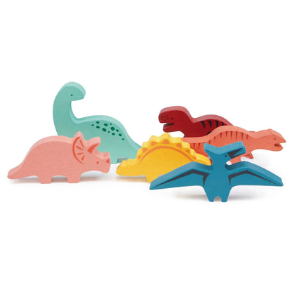 Set of colourful dinosaur-shaped bath toys on a white background