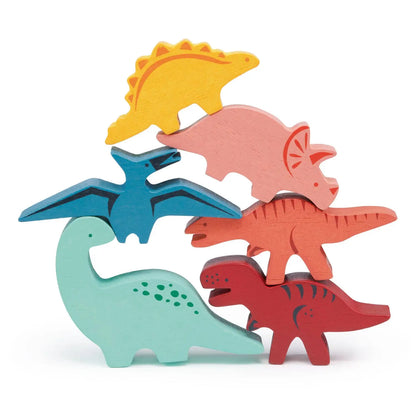 Set of colourful wooden dinosaur toys stacked on a white background
